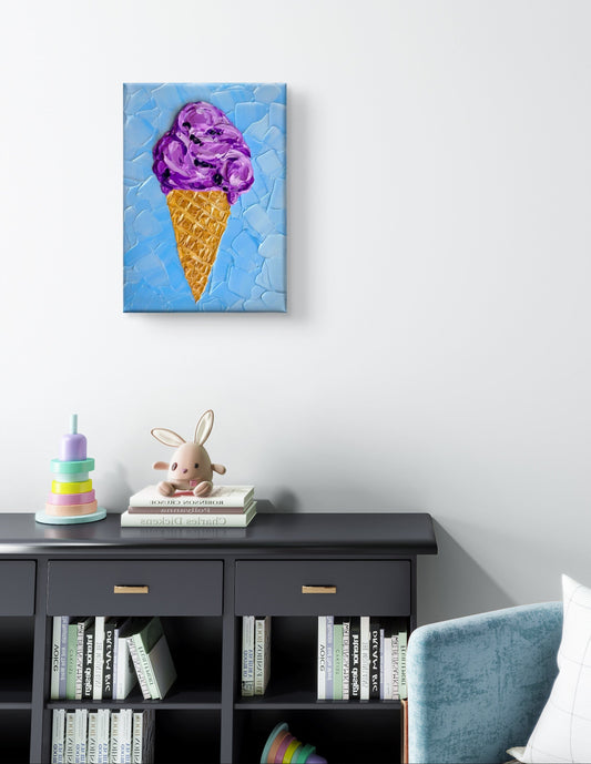 A 5x7" original textured painting depicting a purple ice cream cone on a textured light blue background, displayed on a white wall above a dark bookcase in a styled room setting.